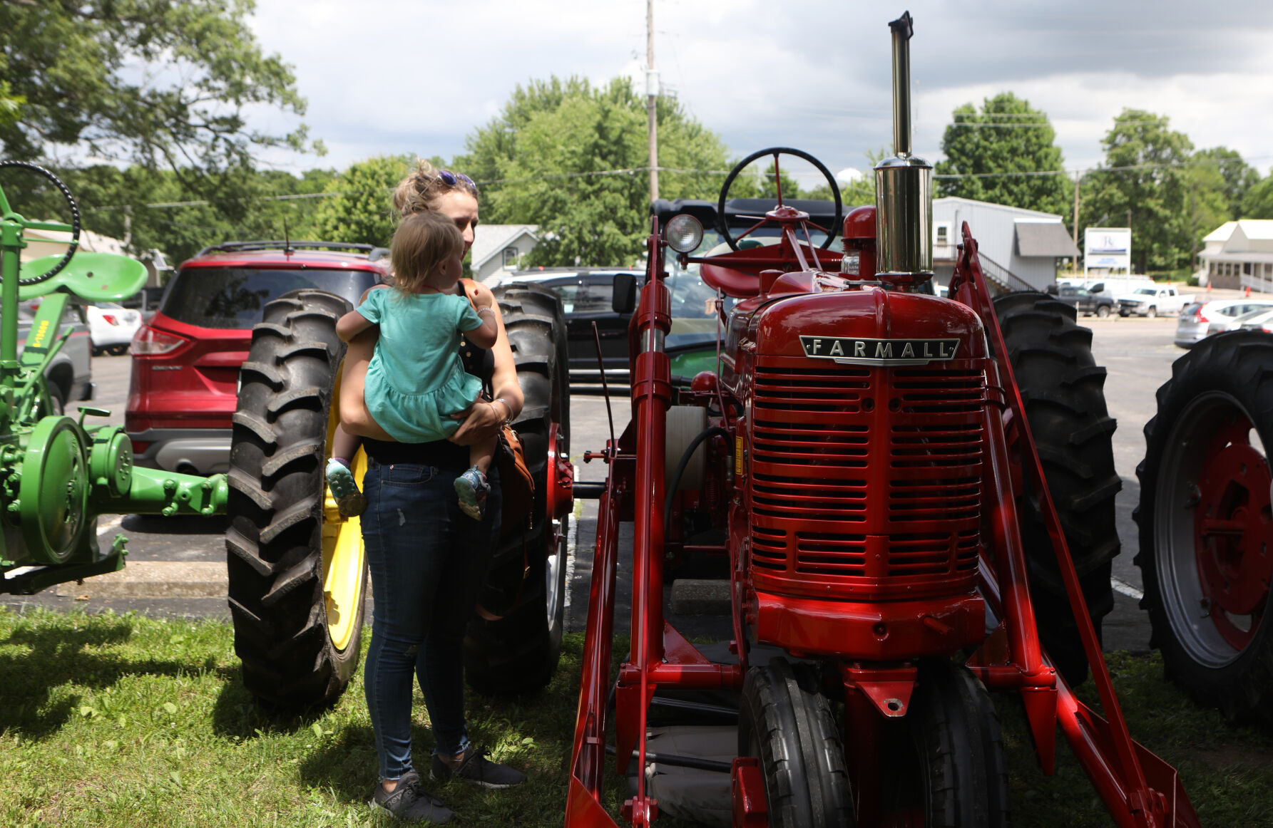 Katie and Abigail Curran look at tractors